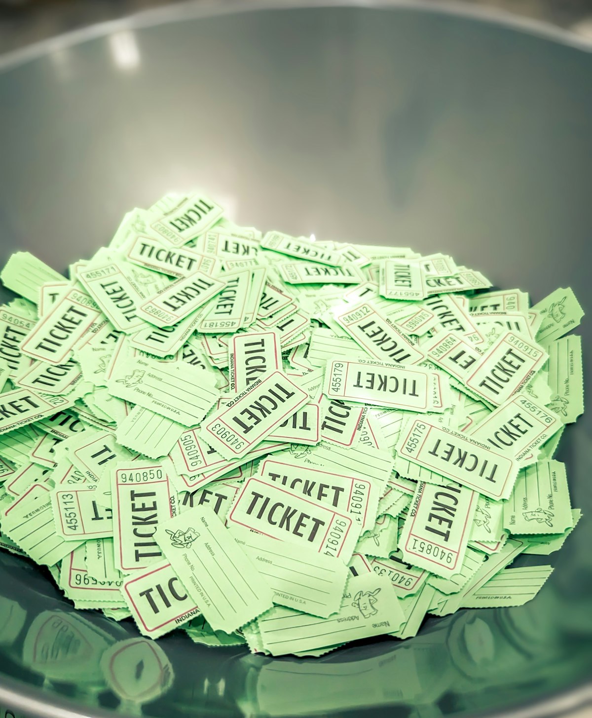 A draw bowl full of numbered raffle tickets
